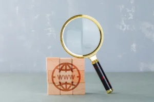 Conceptual internet search with wooden blocks with internet icon magnifying glass side view